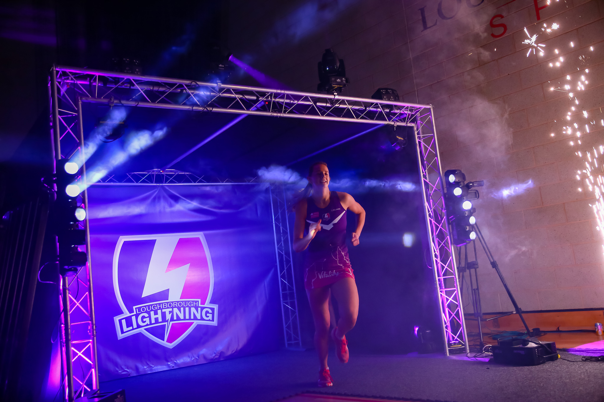 a person standing on a stage with the Lightning logo in the background